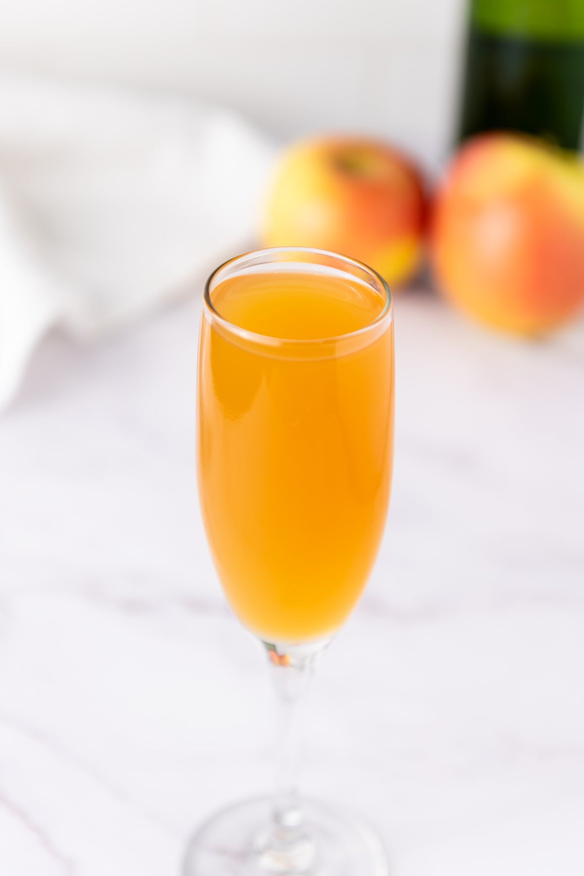 Finished Apple Cider Mimosa garnished with a cinnamon stick ready to serve