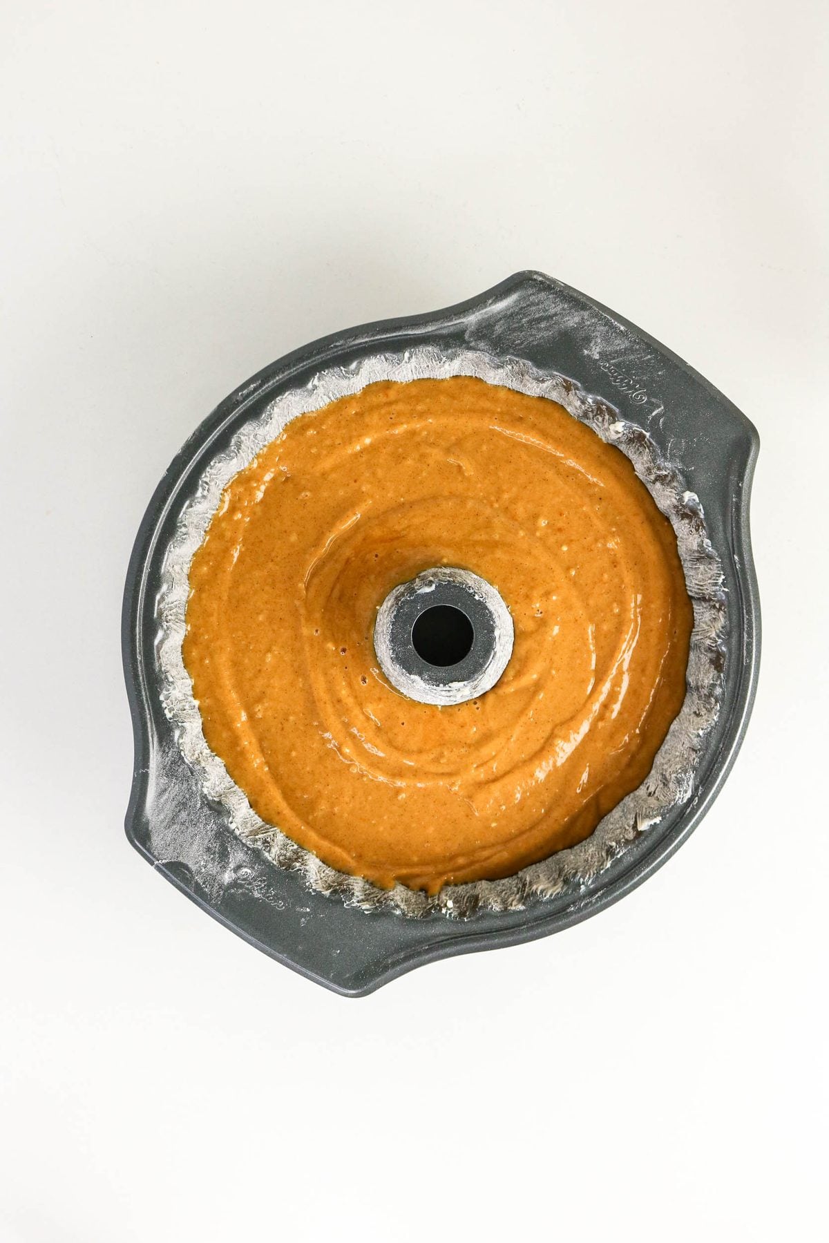 Cake batter in a fluted Bundt pan ready for the oven.